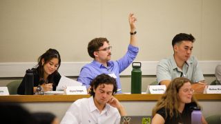 student raising hand